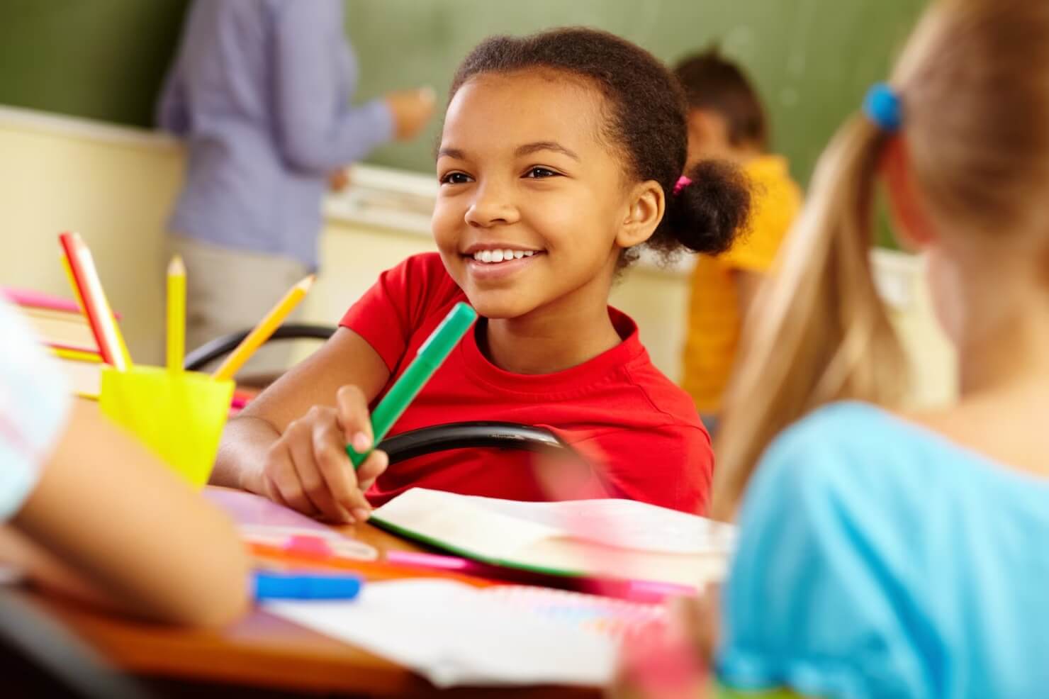 Criança em sala de aula sorrindo